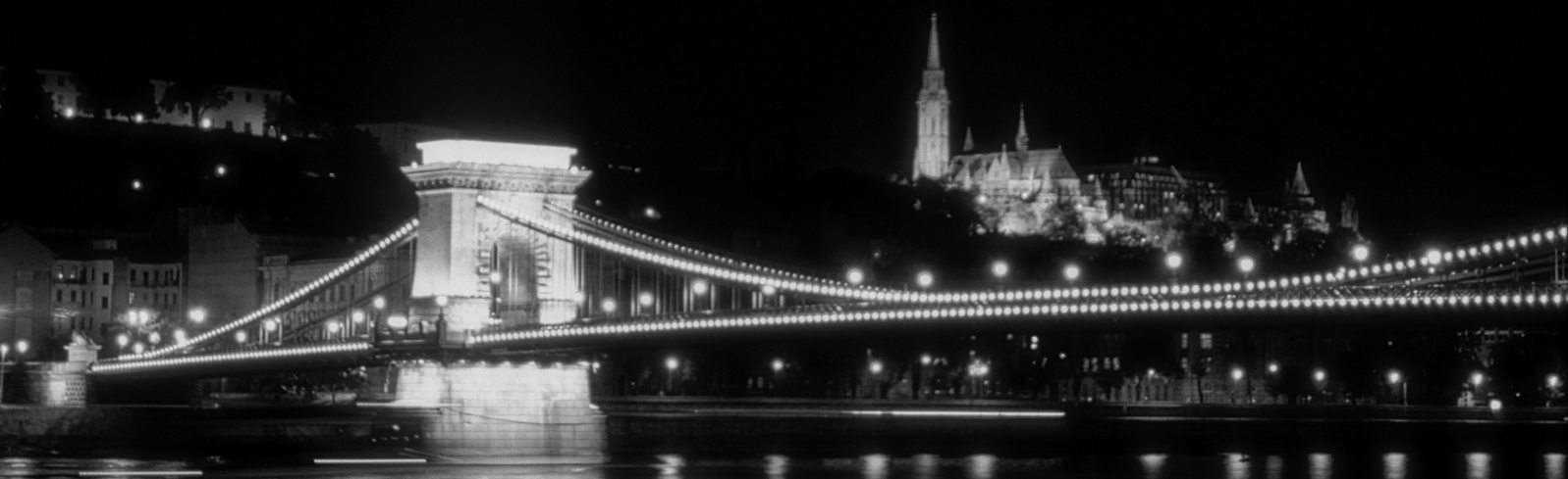 Il ponte delle catene fotografato di notte e illuminato dalle luci artificiali.