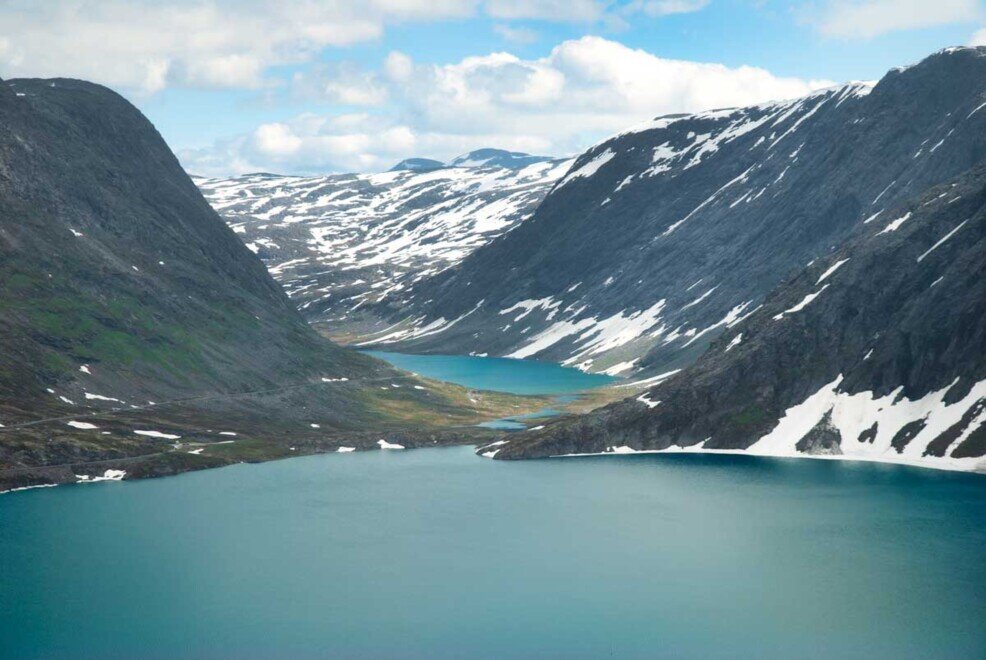 Il lago Djupvatnet con le acque turchesi che riflettono la luce del cielo e delle montagne circostanti.