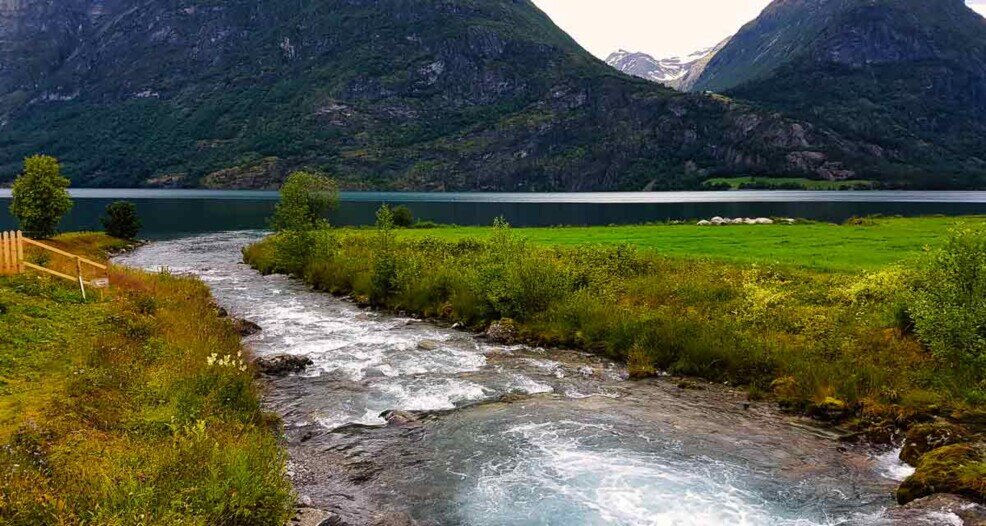 Il lago nel fiordo circondato da montagne a Hjelle.